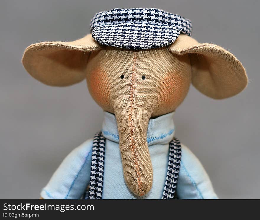 Handmade elephant in a plaid cap