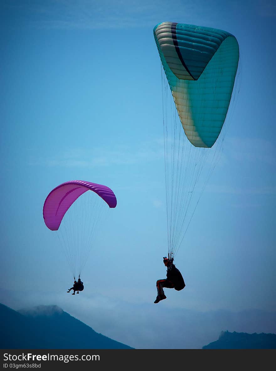 Paragliders soaring in a blue sky