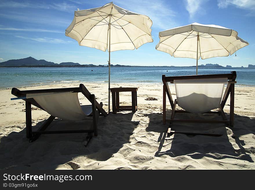 Tropical beach front with coconut tree and beach chair