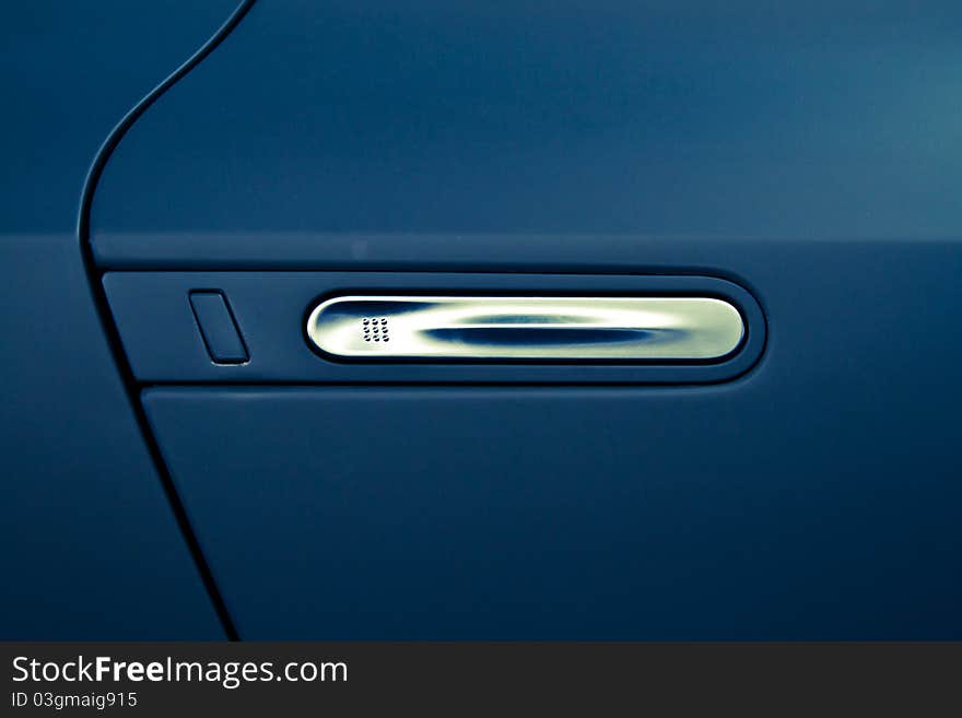 Aluminum door handle on a blue car