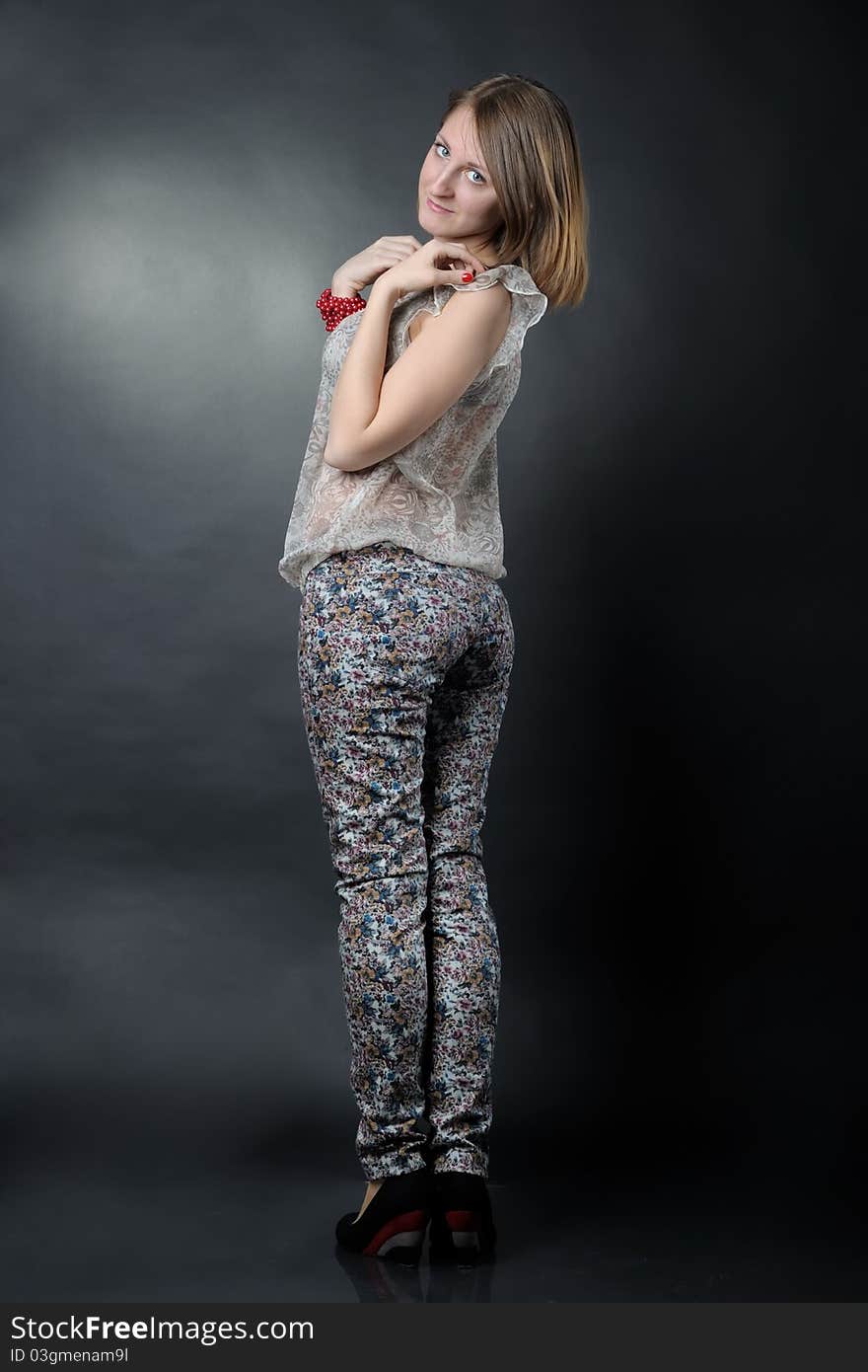 Slim girl in studio on black background