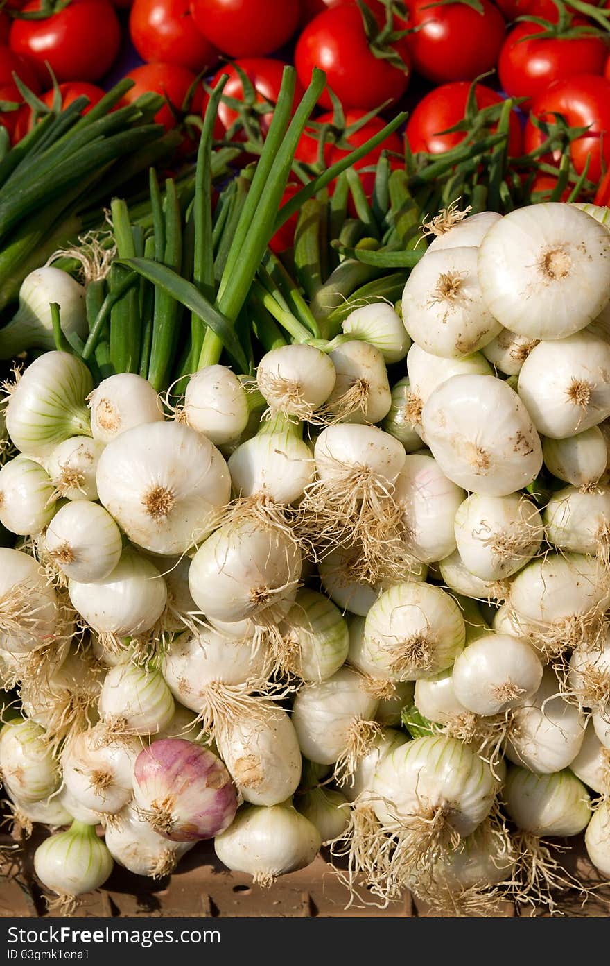 Fresh onions and tomatoes on the market counter. Fresh onions and tomatoes on the market counter