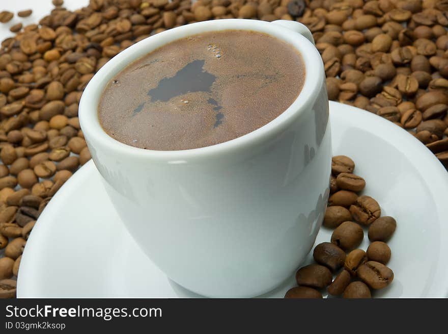 A cup of coffee and coffee beans