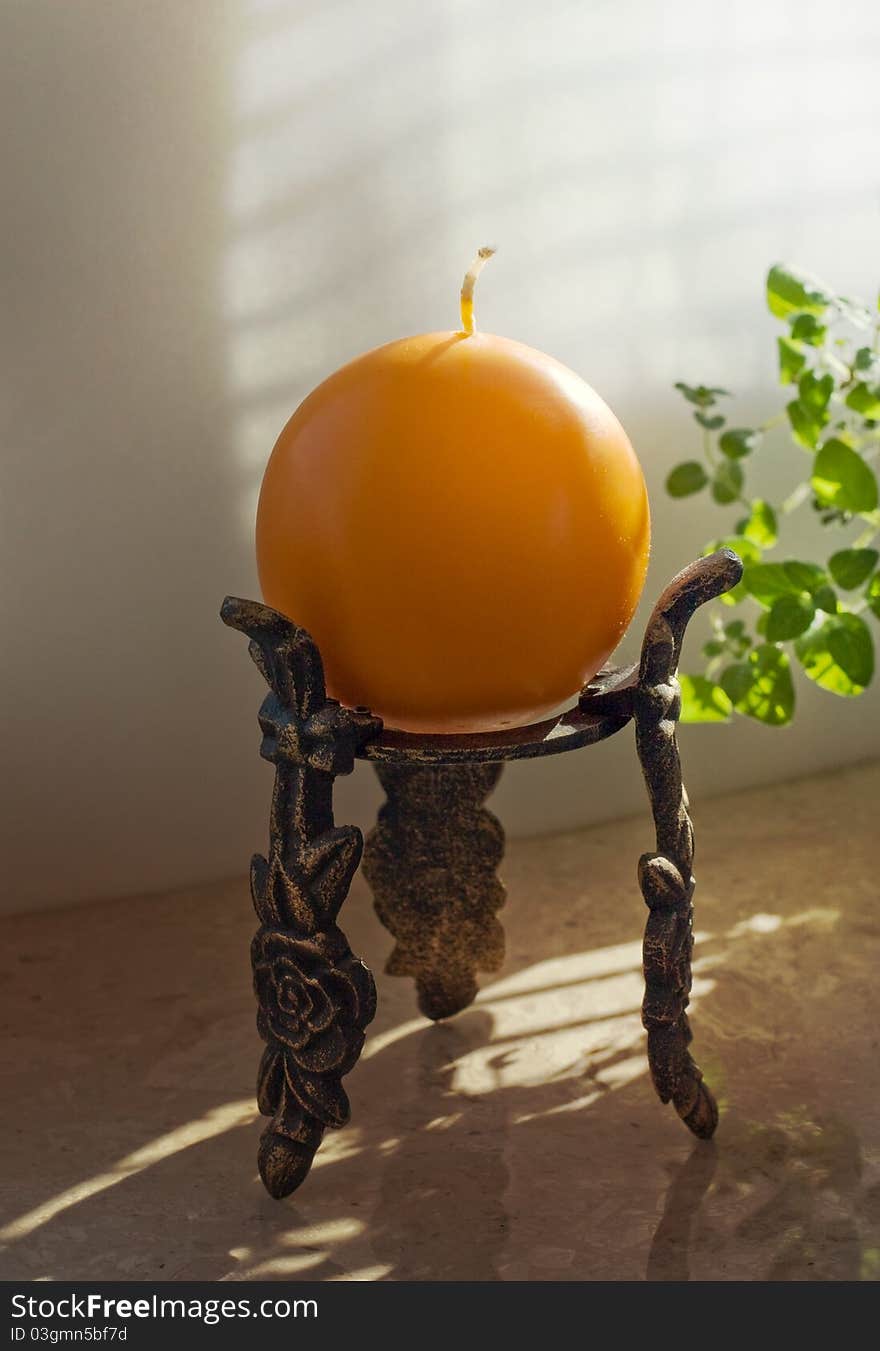 Classic candlestick with an orange candle