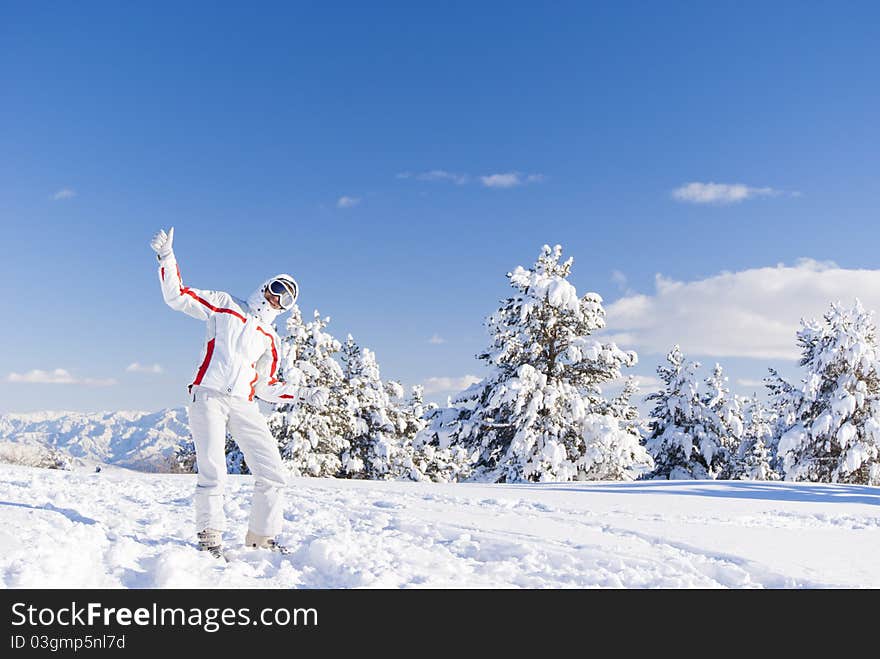 Happy skier on the top of mountain