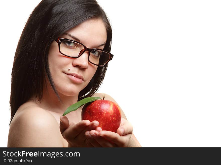 The beautiful girl wearing spectacles with an apple in a hand on a white background