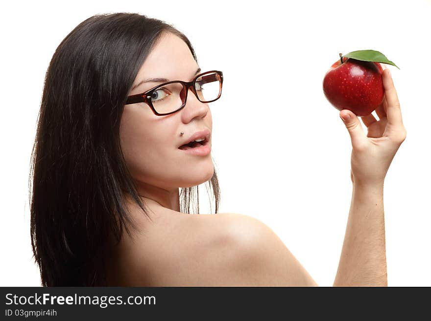 The beautiful girl wearing spectacles with an apple in a hand on a white background