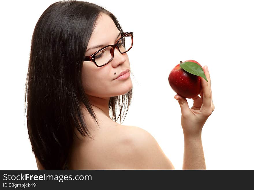 The beautiful girl wearing spectacles with an apple in a hand on a white background