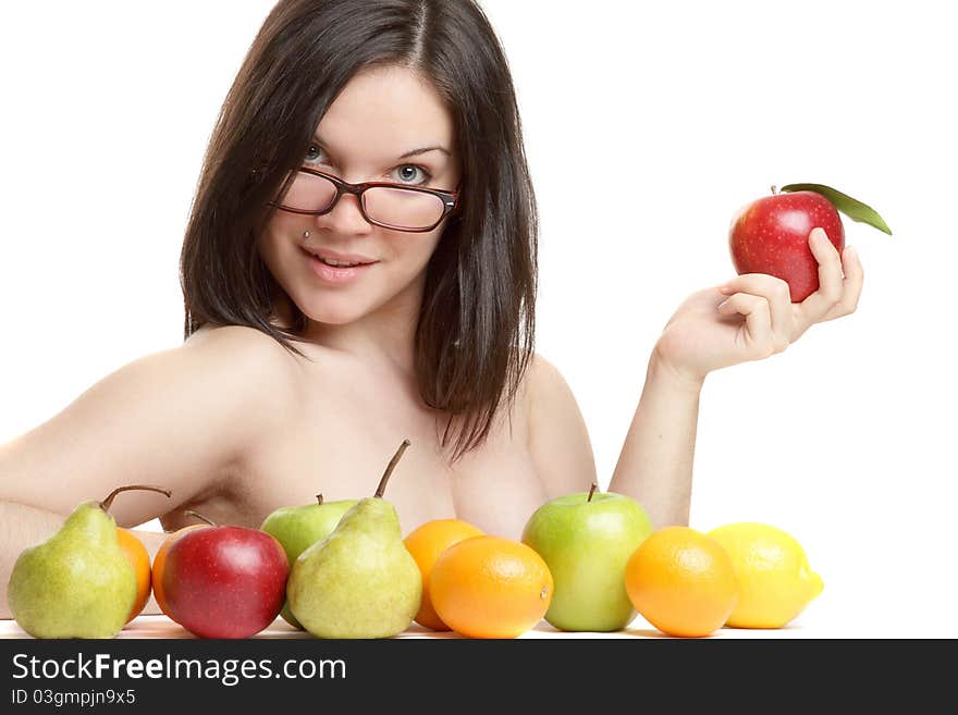 The beautiful girl wearing spectacles with an apple in a hand on a white background