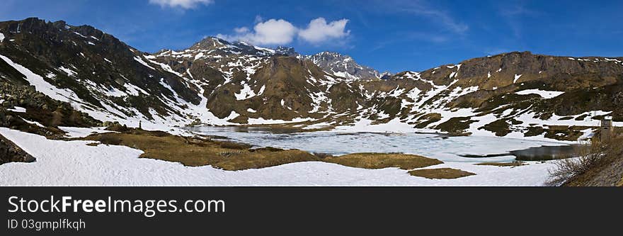 Mountain frozen lake in spring on alps in spring. photo taken in may at 2000 meters on the sea level.