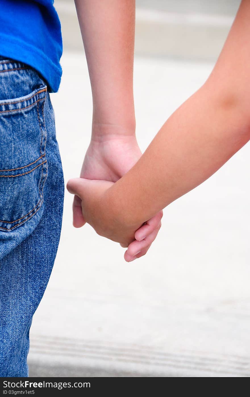 A brother and sister holding hands.