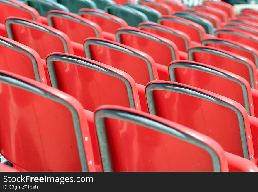 Red plastic stadium seats - back view