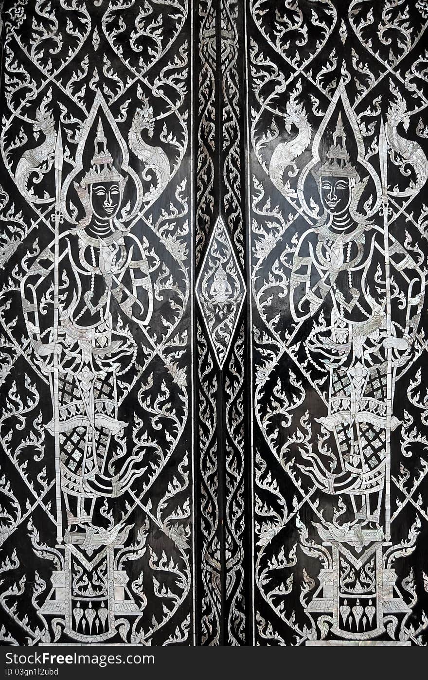 Traditional Thai style painting art on door in Buddha Temple