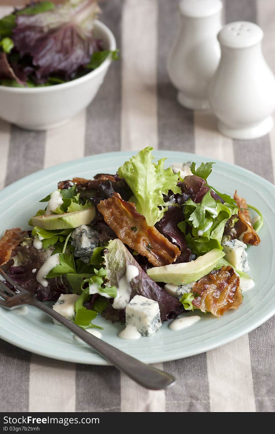 Gorgonzola, lettuce and pancetta salad with avocado on a plate. Gorgonzola, lettuce and pancetta salad with avocado on a plate