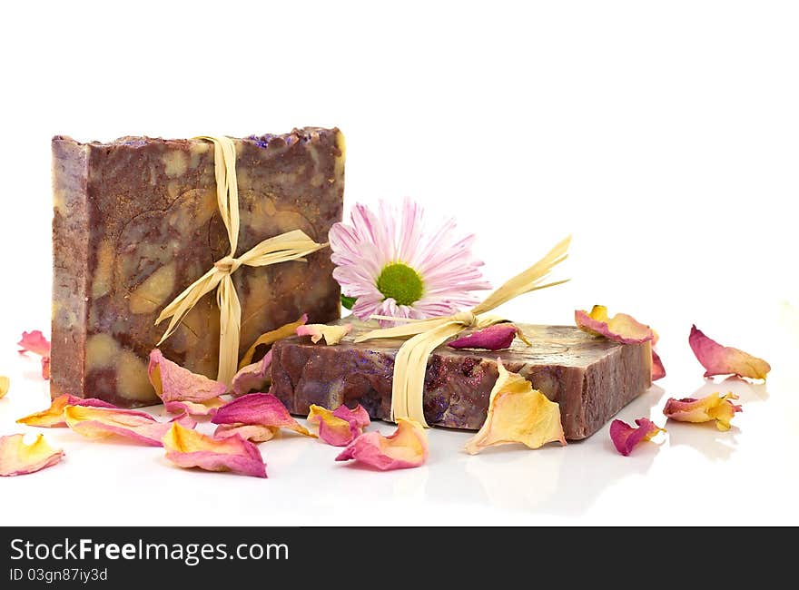 Natural handmade silk soap and pink flower on a white background. Natural handmade silk soap and pink flower on a white background.