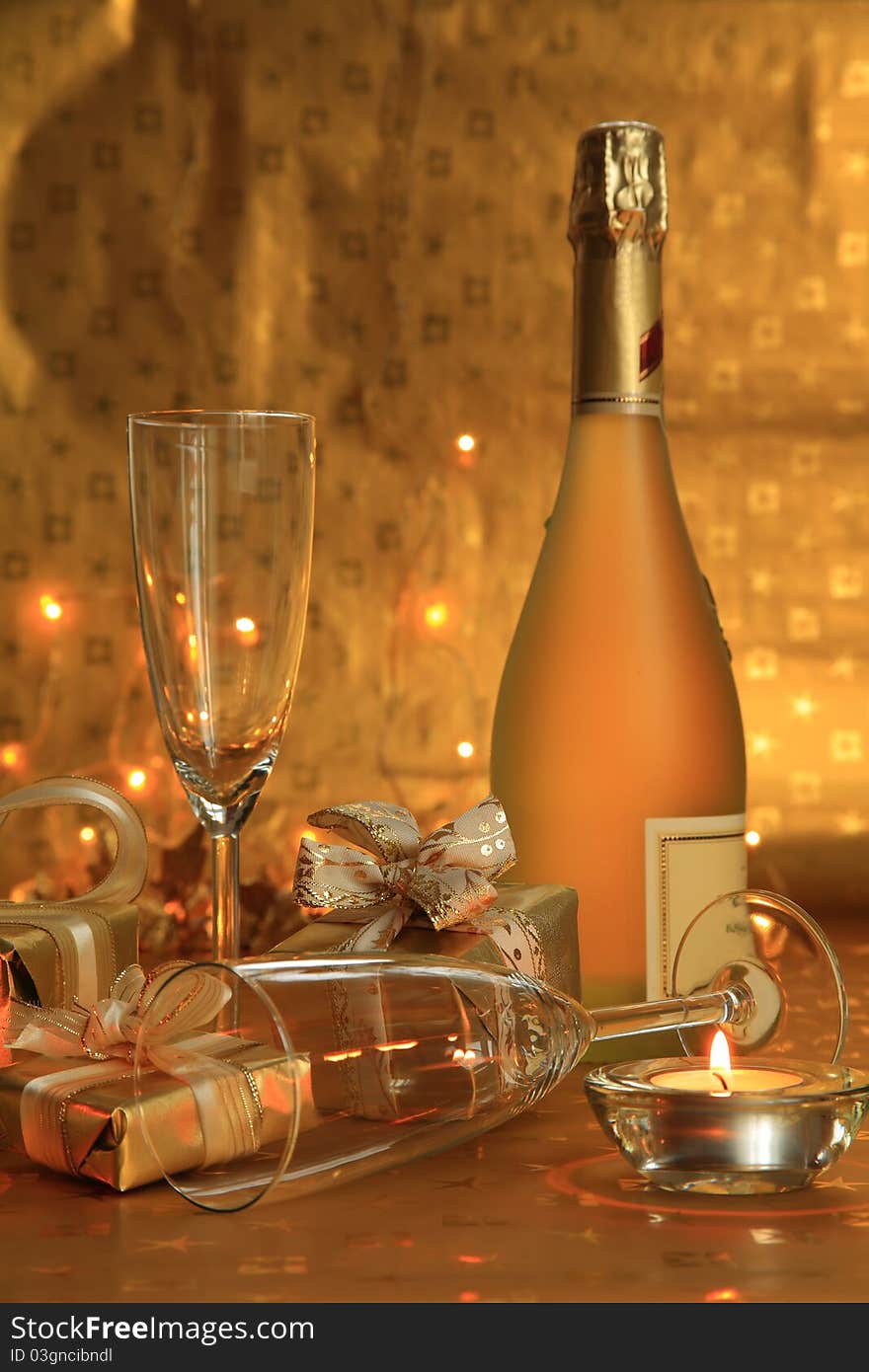 Bottle of champagne, glasses and gifts