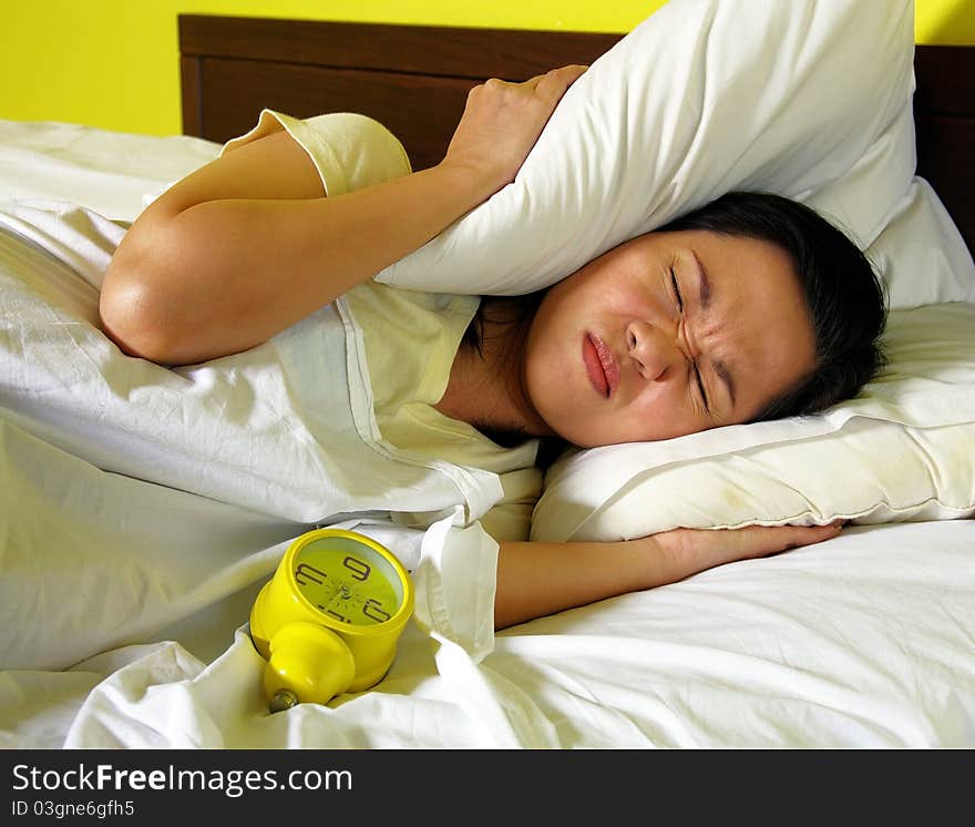 Woman and alarm clock in bedroom. Woman and alarm clock in bedroom