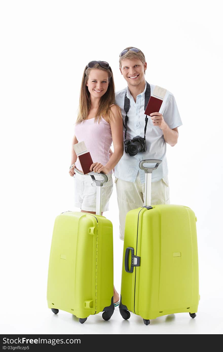 Attractive young couple with suitcases and passports isolated. Attractive young couple with suitcases and passports isolated