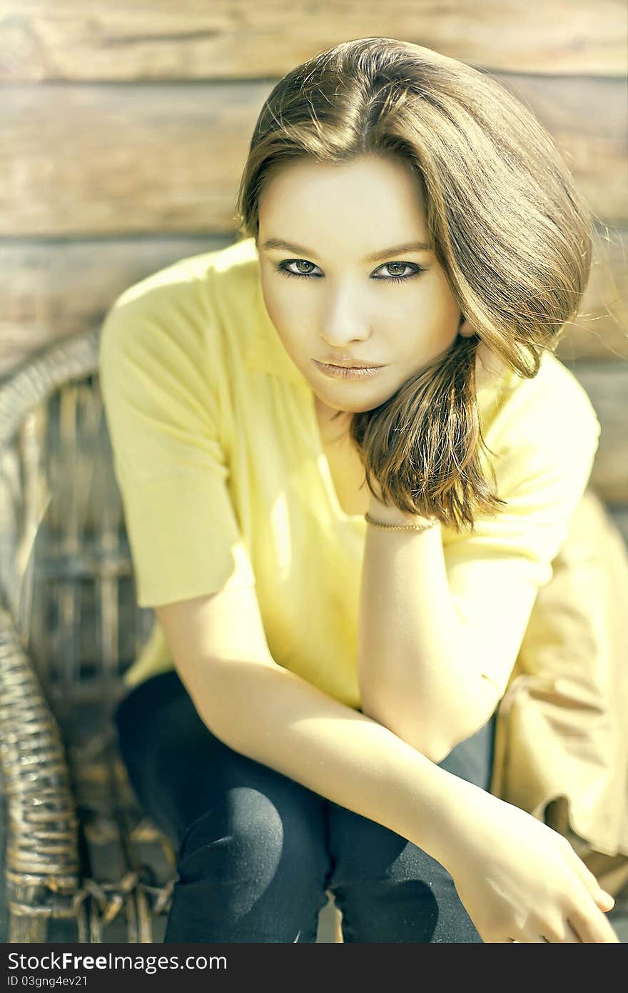 Stunning brunette beauty sitting on a chair