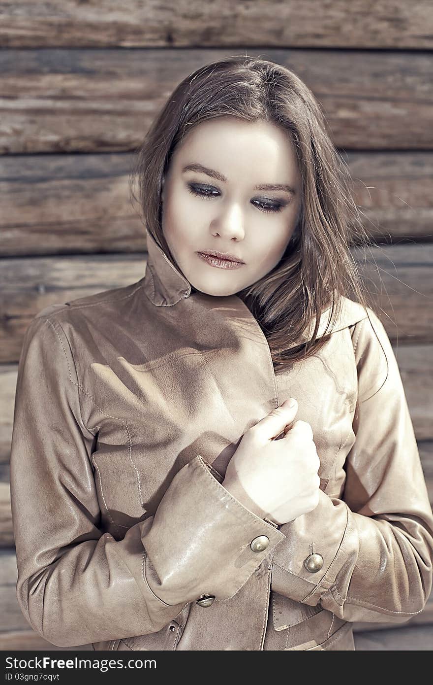 Girl in leather jacket. Brunette with bright makeup