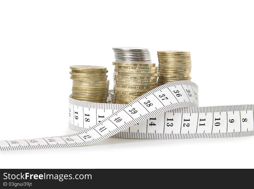 Stack of coins and tape measuring isolated on white