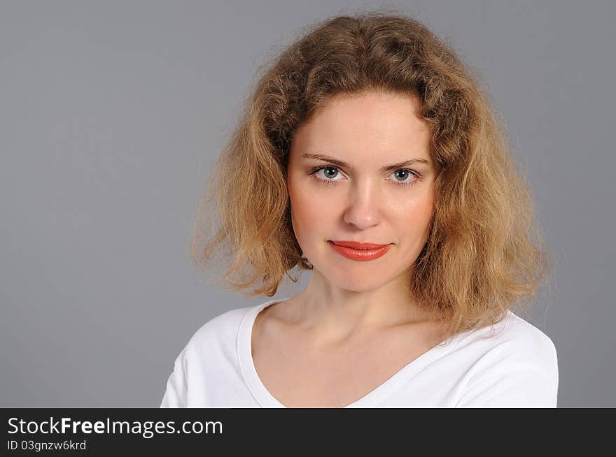 Portrait of the woman, on a grey background. Portrait of the woman, on a grey background