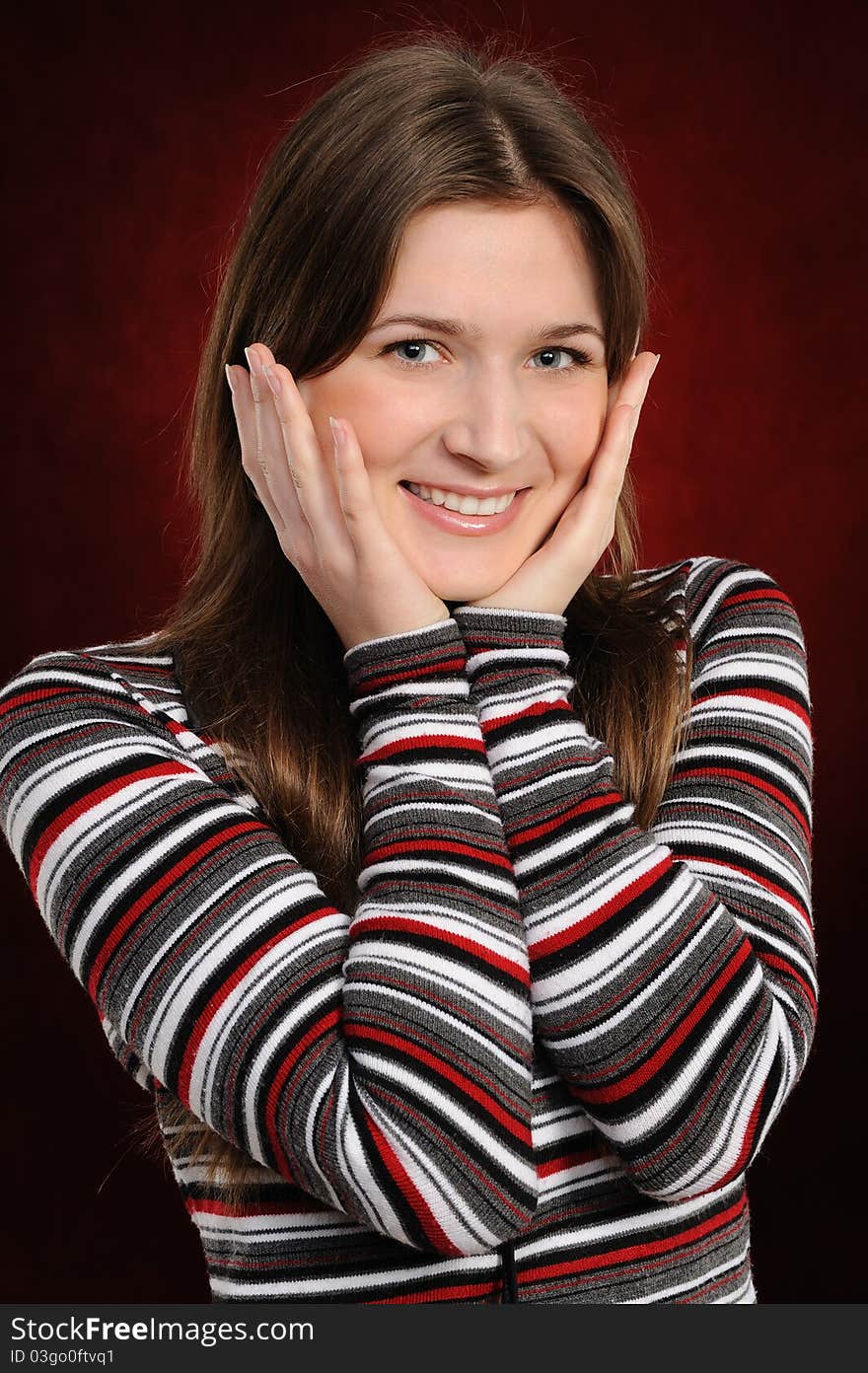 Portrait of the attractive woman on a red background