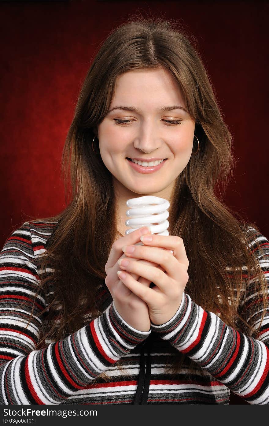 Woman holding an fluorescent light bulb