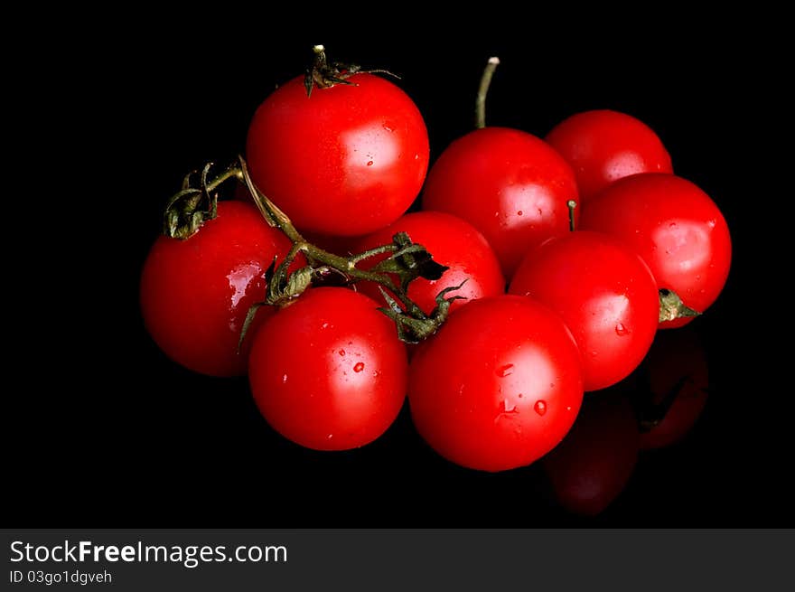 Red cherry isolated on a black background