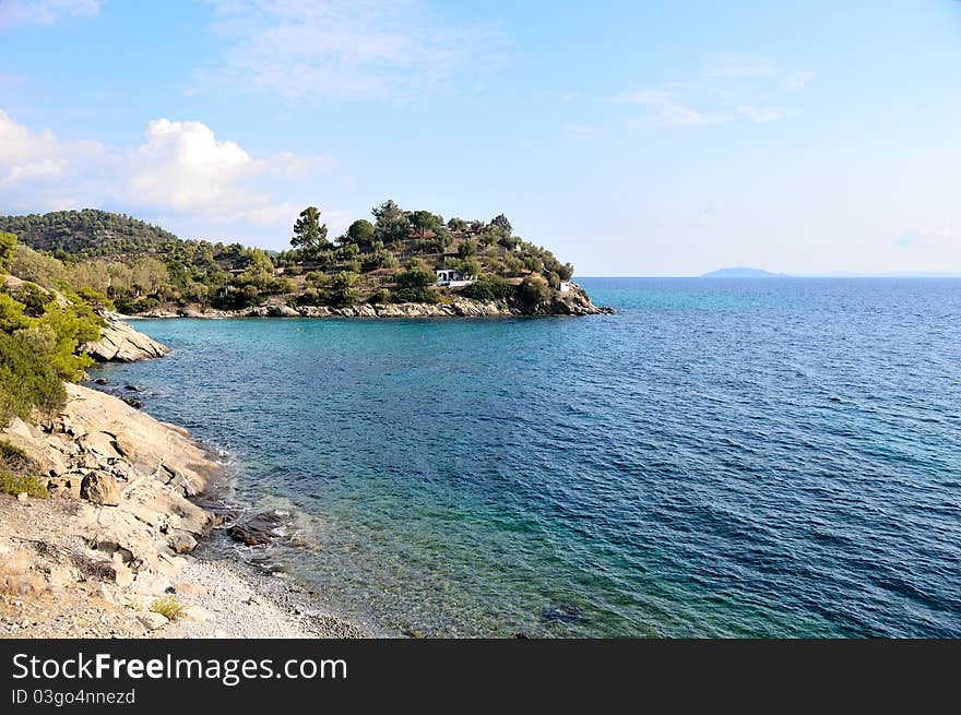 Small peninsula in the mediterranean sea, under the summer sun.