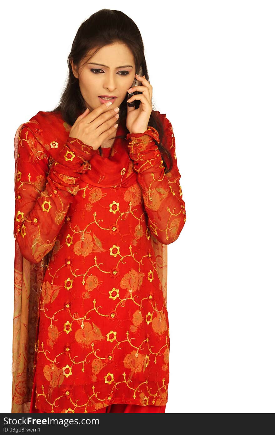 Surprise - A very surprised cute young Indian girl talking on mobile phone against white background