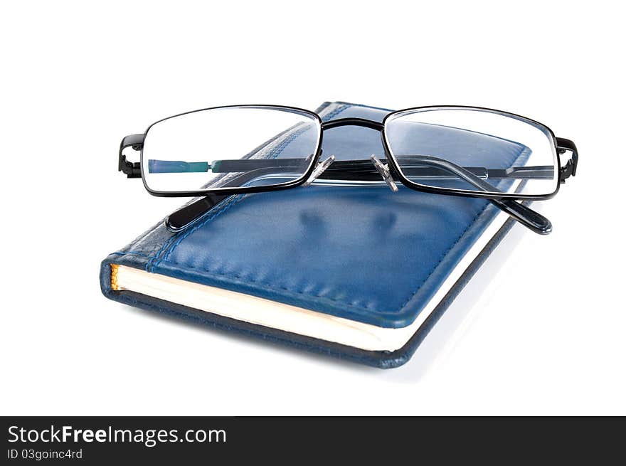 Blue notebook and glasses