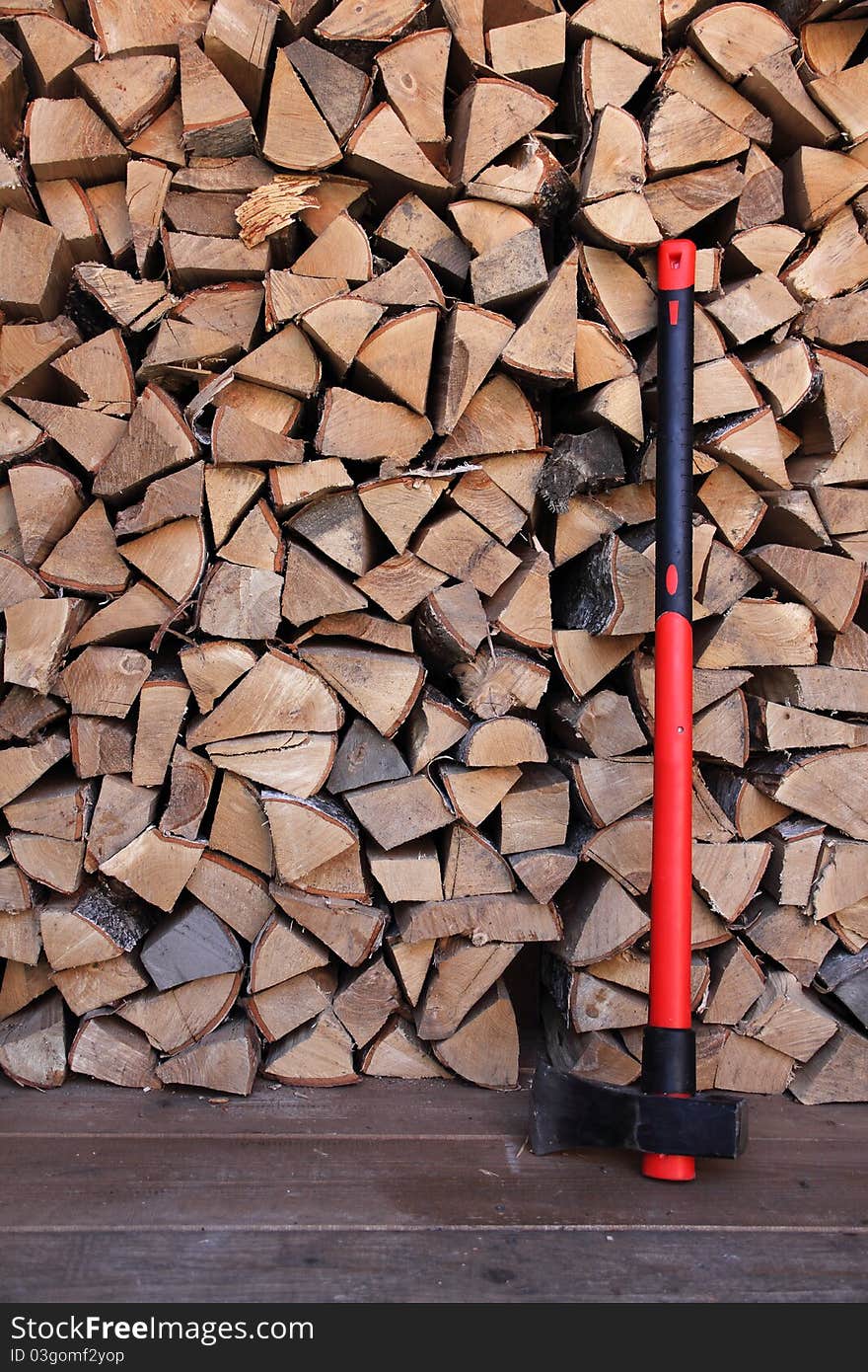 Axe with red handle and firewood. Axe with red handle and firewood