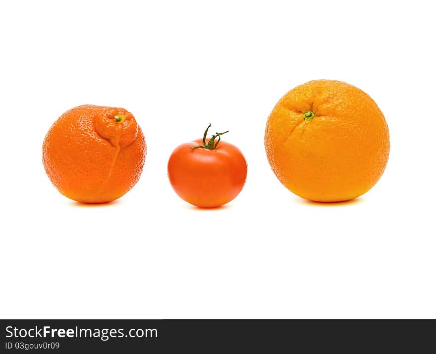 Tangerine, tomato and orange closeup on white background. Tangerine, tomato and orange closeup on white background