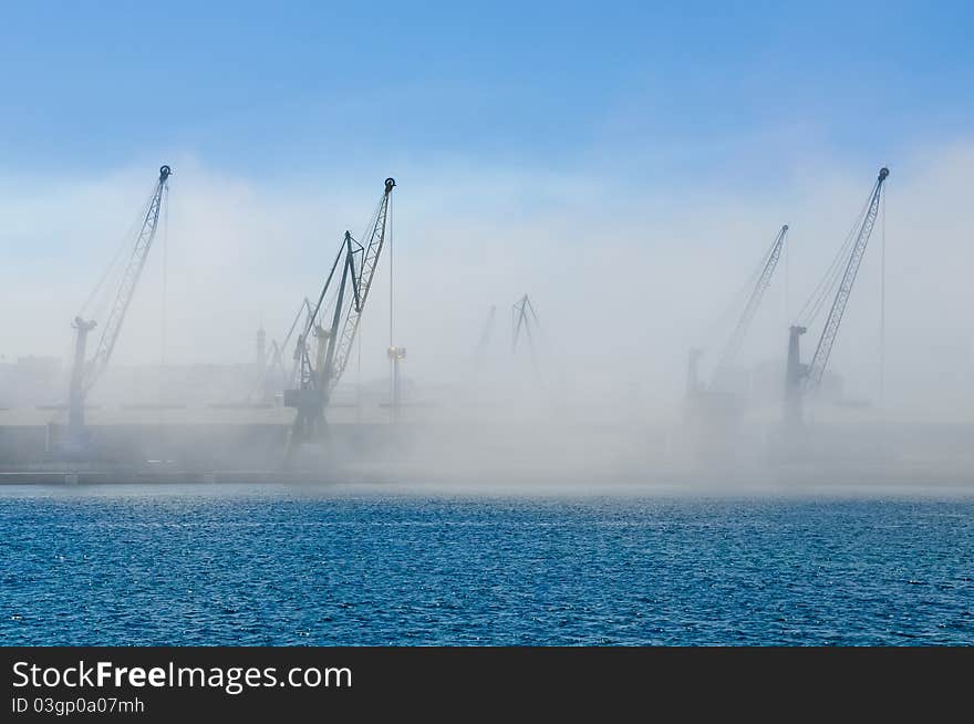 Dockyard cranes in the early morning mist. Dockyard cranes in the early morning mist