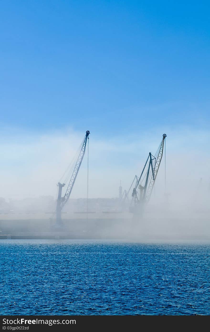 Dockyard cranes in the early morning mist. Dockyard cranes in the early morning mist