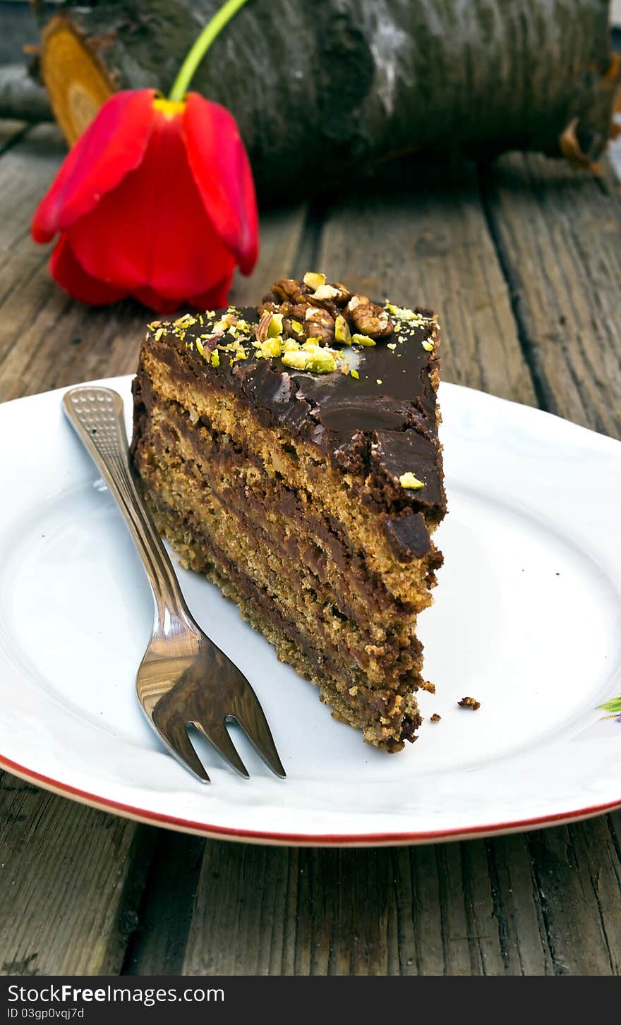 Piece homemade chocolate cake in a white plate and fork. Piece homemade chocolate cake in a white plate and fork