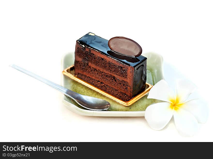 Chocolate cake with spoon and flower