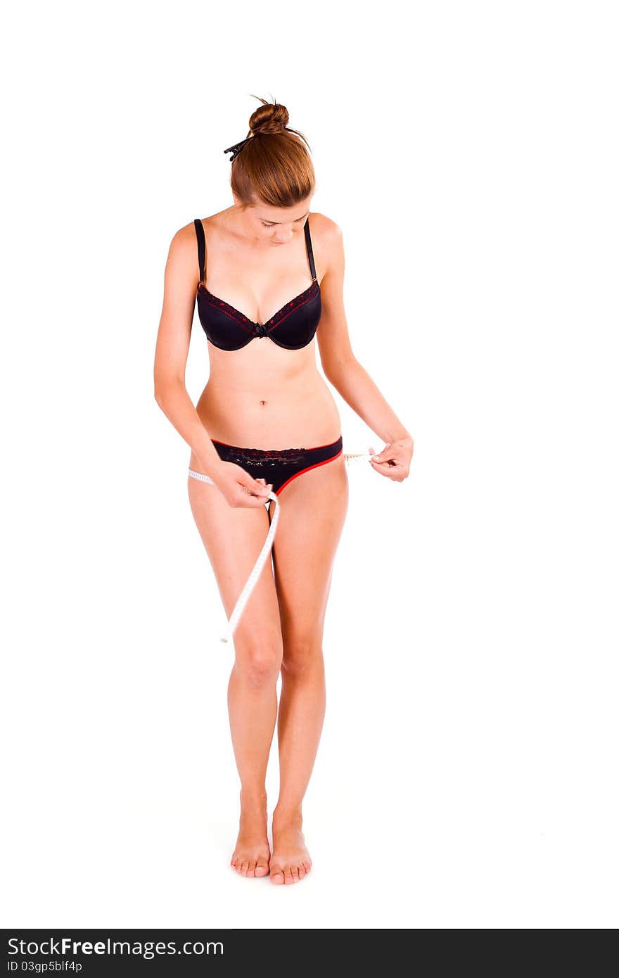 Young Caucasian woman measuring her slim body