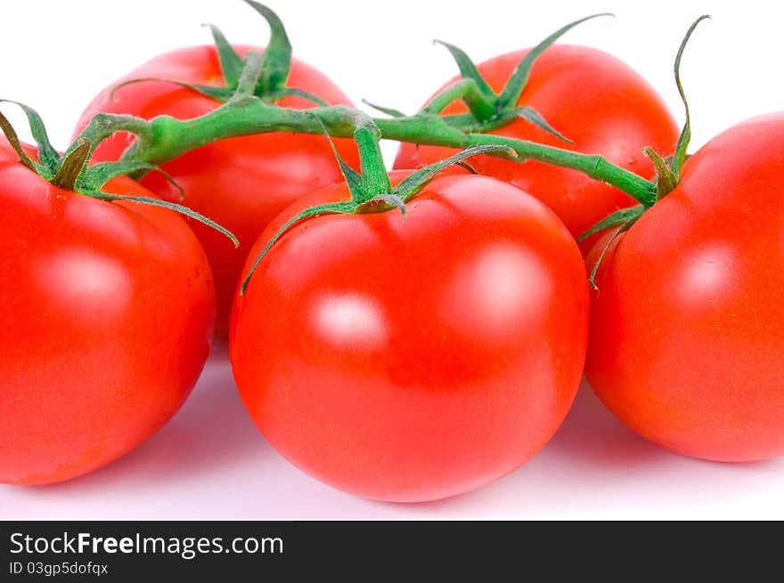 Close-up shot of red appetizing tomatoes on white background