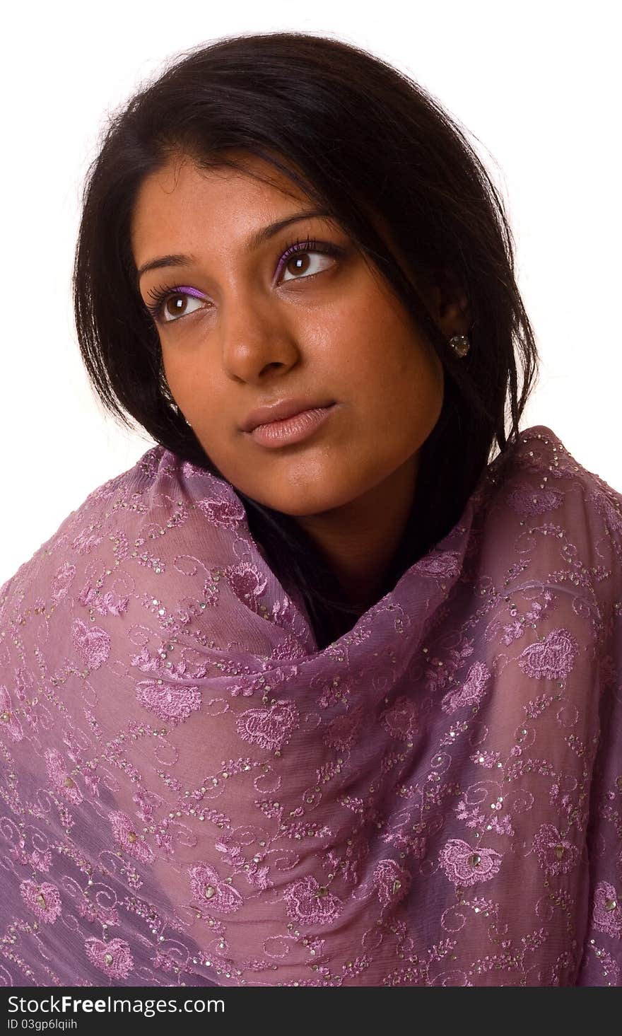 A young asian woman dressed in a pashmina scarf.