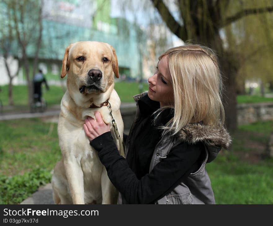 Beautiful woman with dog in the park