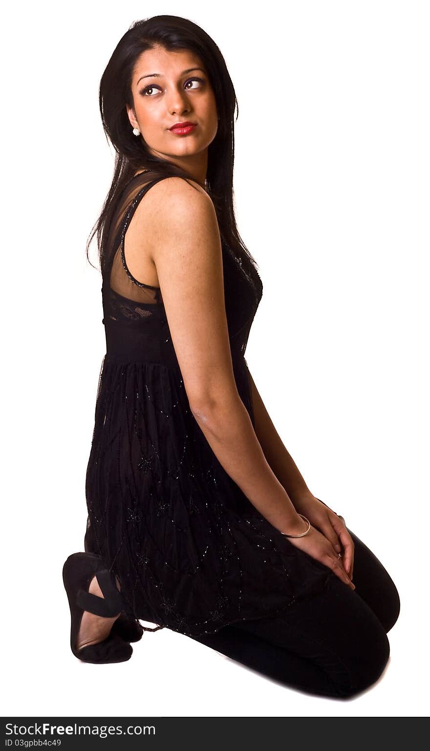 An asian woman kneeling isolated on a white background.