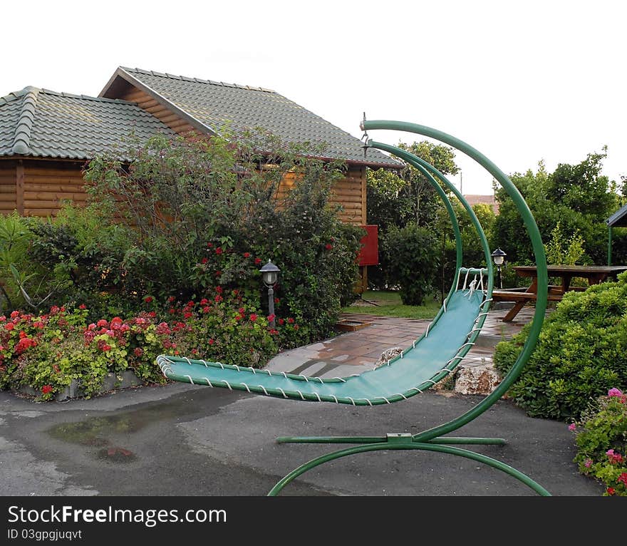 Suspended lounge in garden setting. Suspended lounge in garden setting.