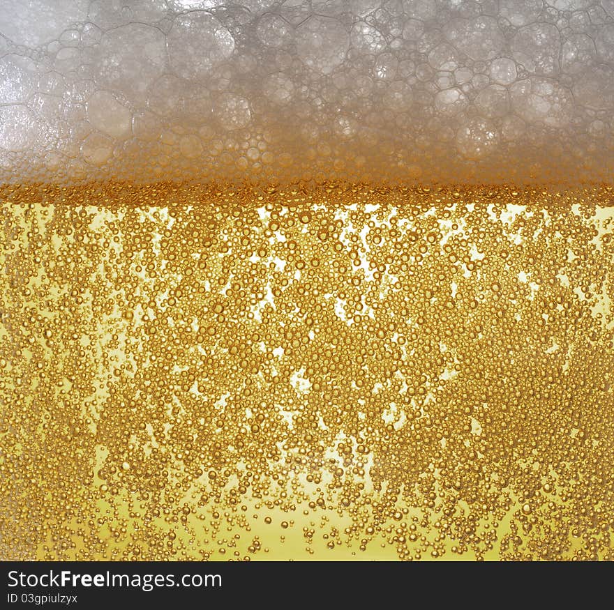 Light beer bubbling with froth. Light beer bubbling with froth