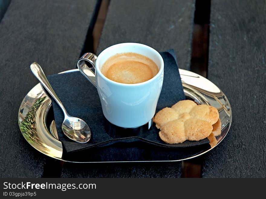 Small metal tray with a cup of coffee and cookies. with a cup of coffee and cookies.