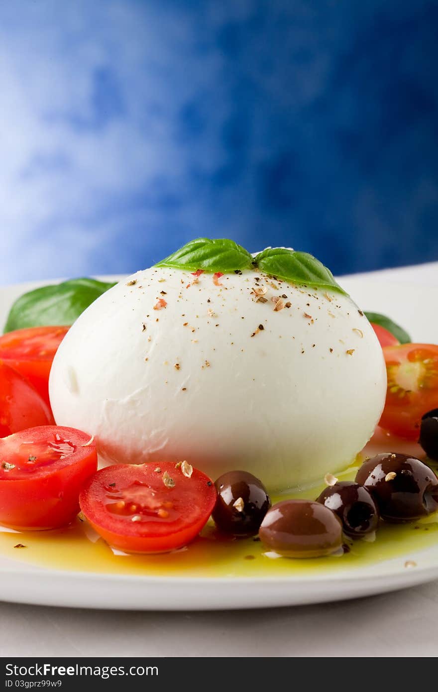 Deliciious buffalo mozzarella with cutted cherry tomatoes and olives over extra vergin oil. Deliciious buffalo mozzarella with cutted cherry tomatoes and olives over extra vergin oil