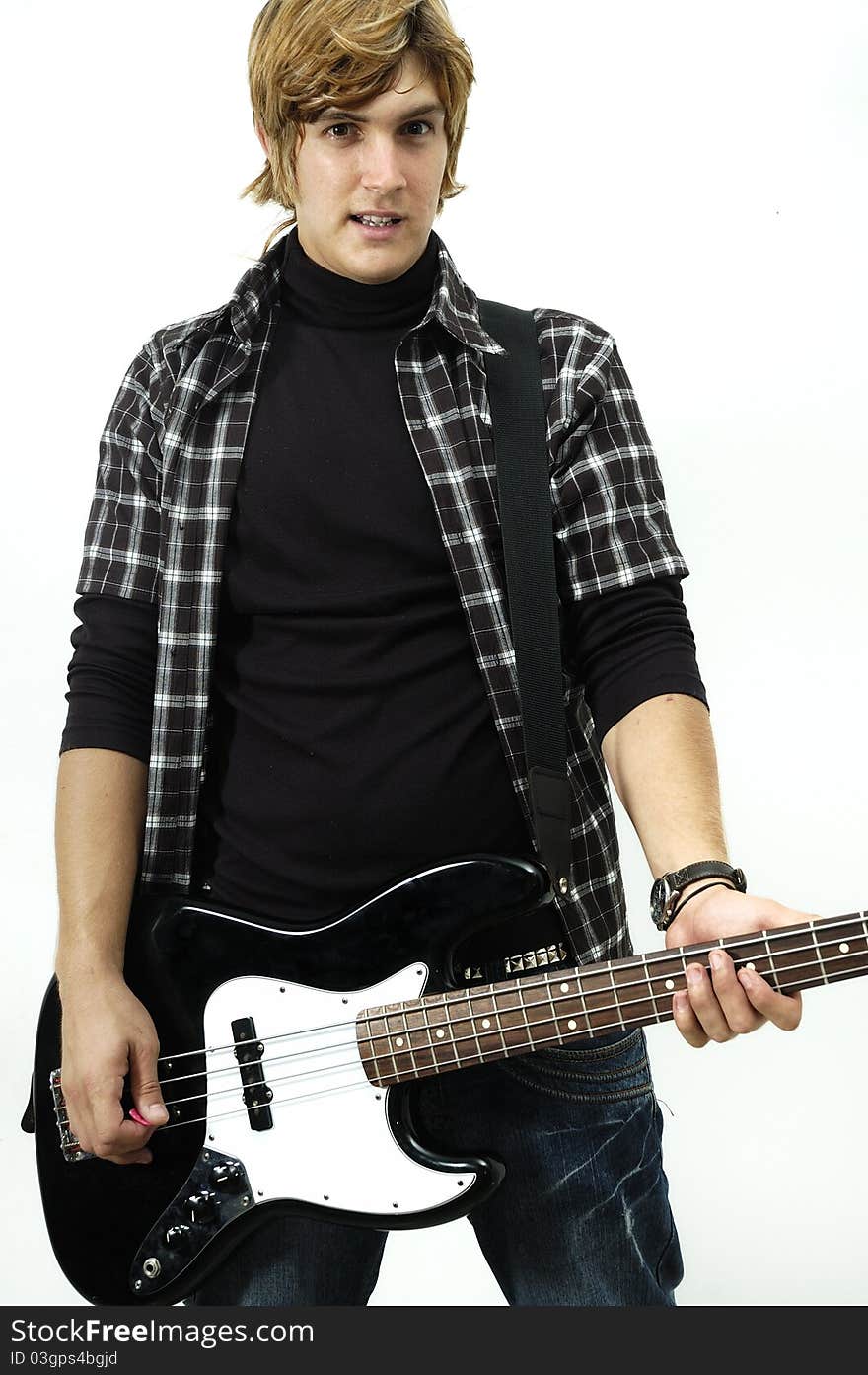 Young man posing with electric bass