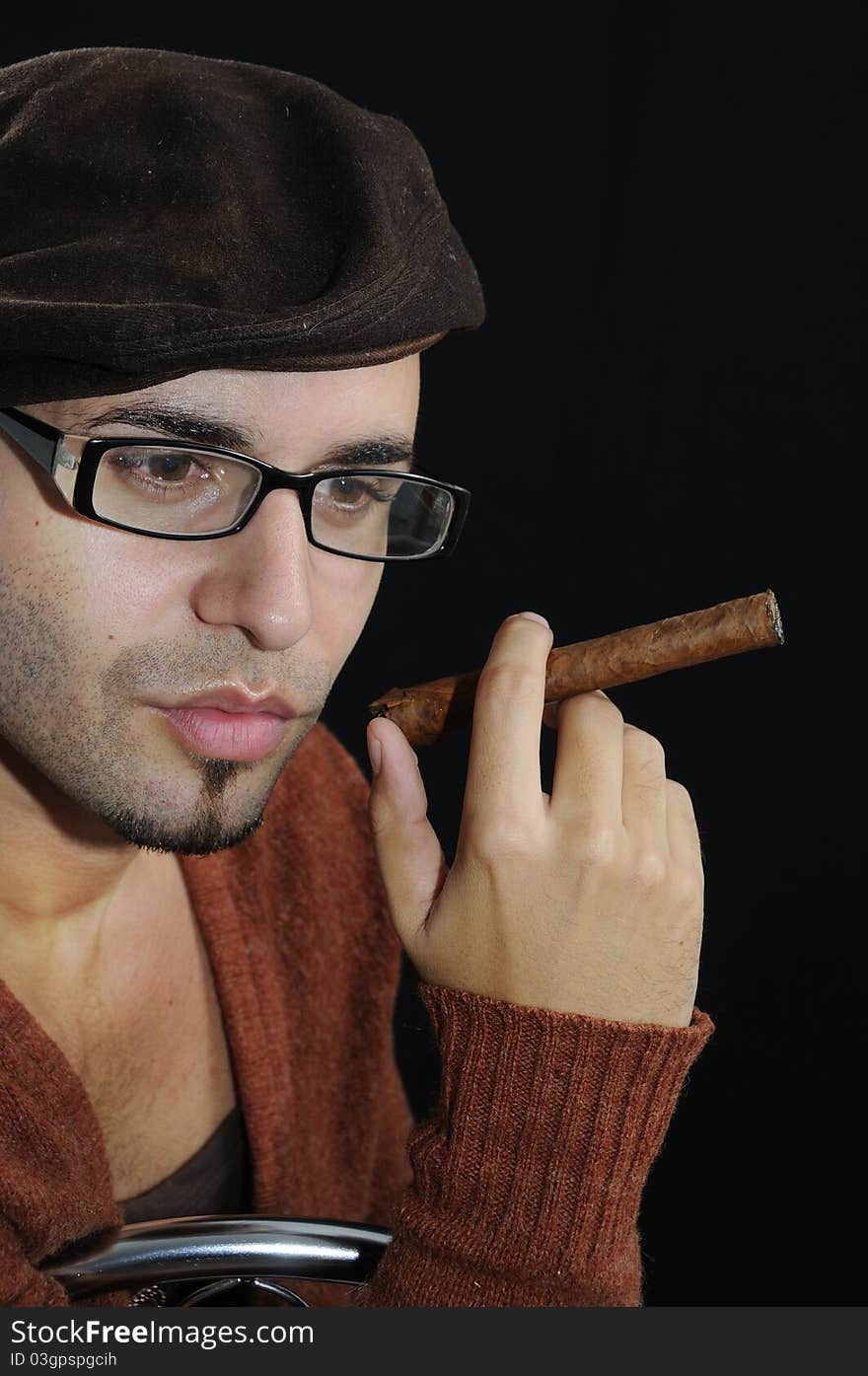 Man holding cigar isolated on black