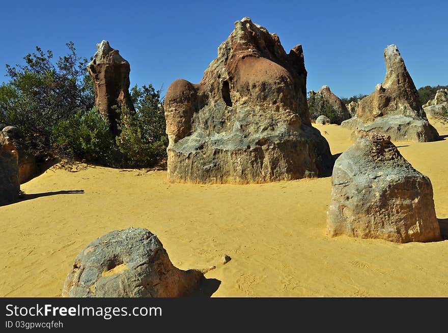 Sedimentary rocks tower over the sand at the Pinnacles in western Australia.